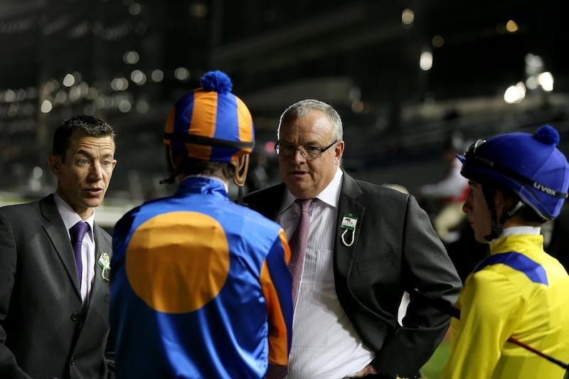 Mike de Kock speaks to jockeys during the first Longines Carnival Meeting at the Meydan Racecourse on January 9, 2014 in Dubai, UAE. Francois Nel / Getty Images