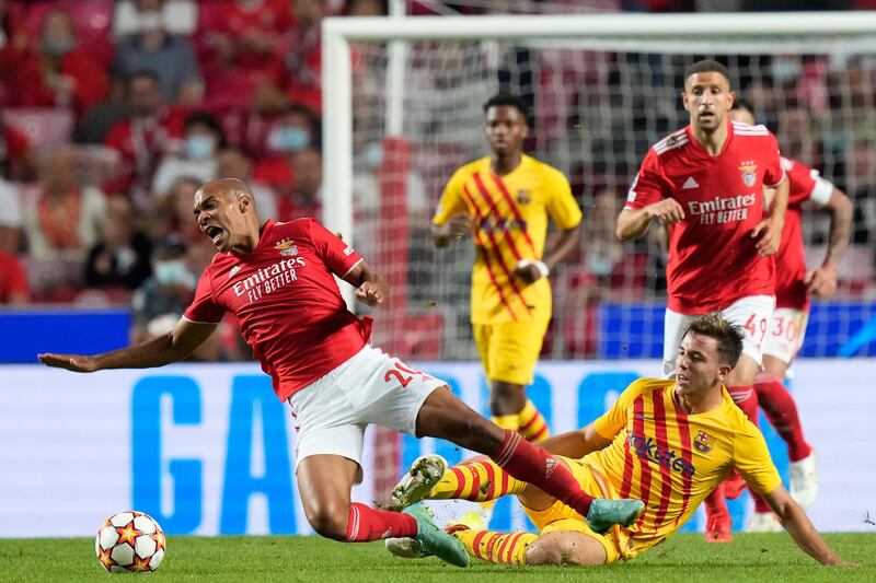 Benfica's Joao Mario is fouled by Nico Gonzalez of Barcelona. AP