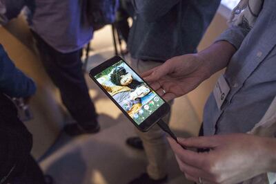 People examine a Google Pixel smartphone. Getty
