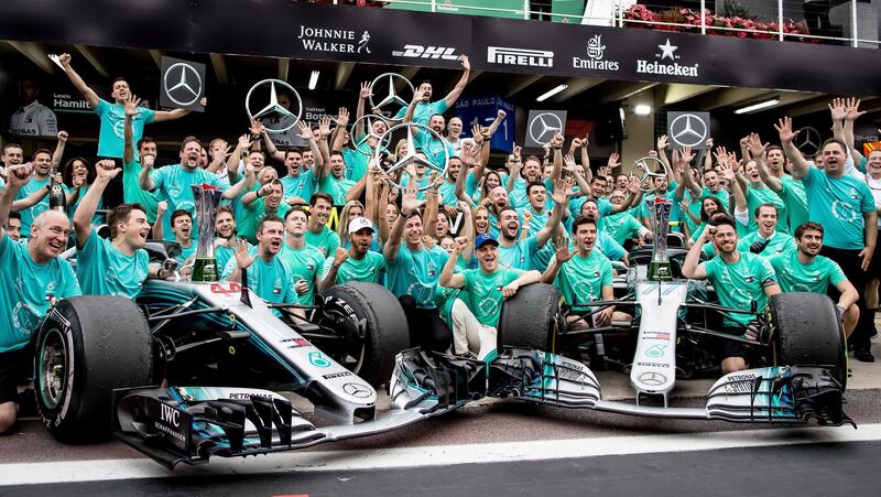 SAO PAULO, BRAZIL - NOVEMBER 11:  Lewis Hamilton of Great Britain and Mercedes GP, Valtteri Bottas of Finland and Mercedes GP, Mercedes GP Executive Director Toto Wolff and the rest of the Mercedes GP team celebrate after winning the F1 Constructors Championship after the Formula One Grand Prix of Brazil at Autodromo Jose Carlos Pace on November 11, 2018 in Sao Paulo, Brazil.  (Photo by Lars Baron/Getty Images)