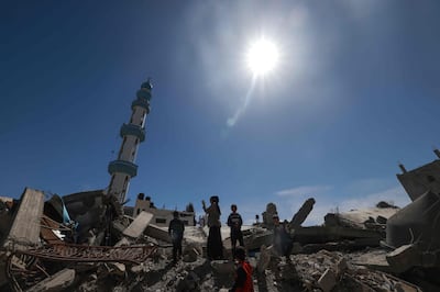 Palestinians amid the ruins of Al Farouq Mosque in Rafah, southern Gaza. AFP