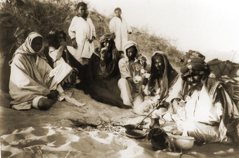 then a photo by traveler Hermann Burchardt of tribes pausing for coffee break in the desert between Hufuf and Qatar dating 1904

Courtesy National Center for Documentation and Research.