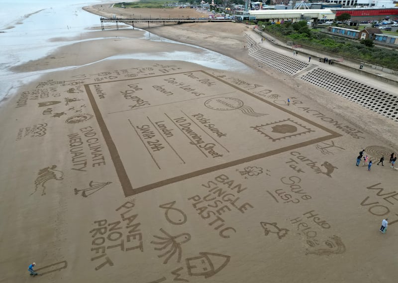 A giant sand drawing in Skegness, England, draws attention to the impact of climate change, which researchers say is deterring people from having children. Getty Images