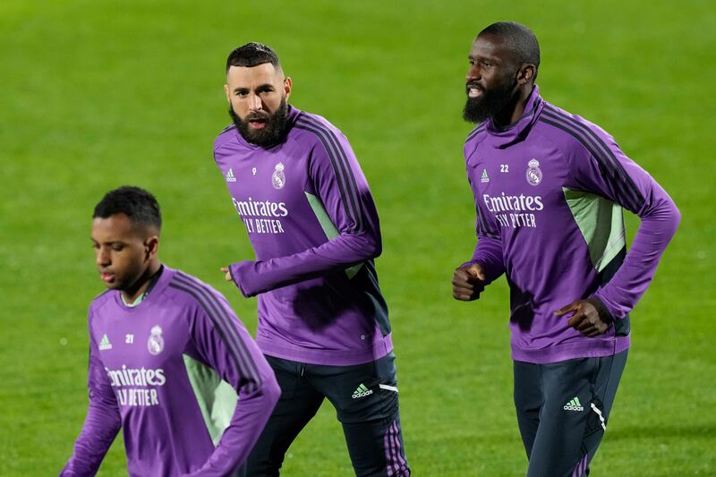 Real Madrid's Karim Benzema, centre, and Antonio Rudiger, right, warm up during training. AP