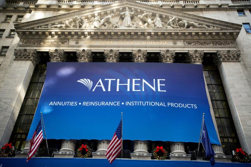 Athene Holding Ltd. signage is displayed outside of the New York Stock Exchange (NYSE) during the initial public offering of the company's stock in New York, U.S., on Friday, Dec. 9, 2016. U.S. stocks were set for a record as oil powered above $51 a barrel on signs producers are following through with agreed production cuts. The dollar rose toward an 18-month high. Photographer: Michael Nagle/Bloomberg