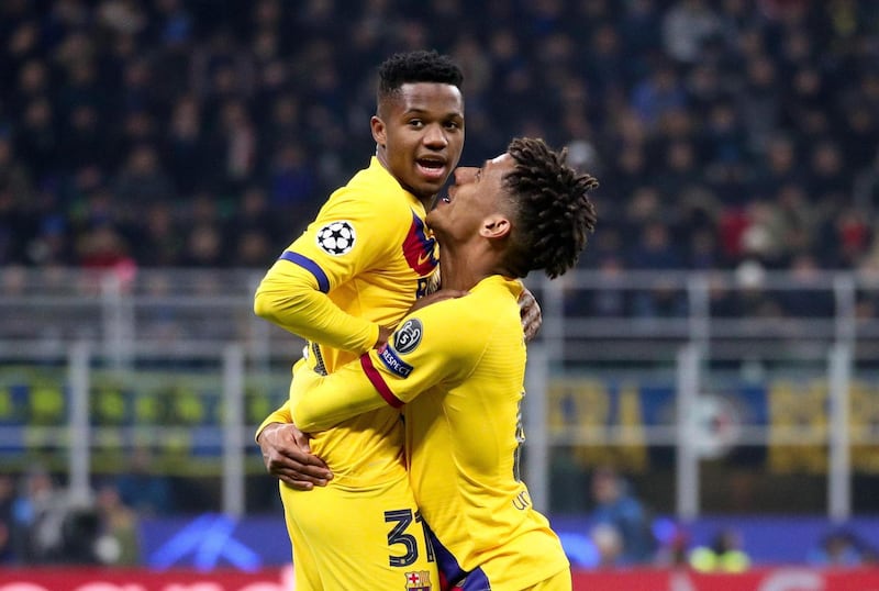 epa08061225 FC Barcelona's Ansu Fati (L) celebrates with teammate Jean-Clair Todibo after scoring during the UEFA Champions League group F soccer match between FC Inter and FC Barcelona at the Giuseppe Meazza stadium in Milan, Italy 10 December 2019.  EPA/ROBERTO BREGANI