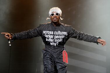 Singer Andre 3000 performing in 2014, wearing a slogan jumpsuit. The same wording now appears on T Shirts being sold in aid of Black Lives Matter. Getty