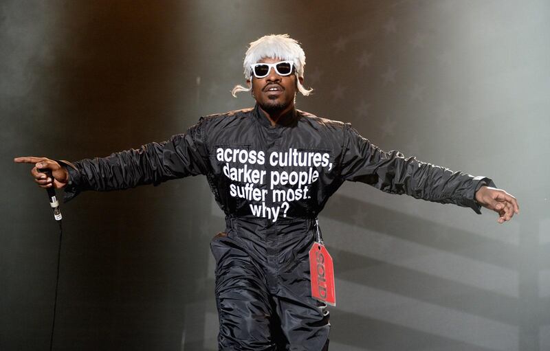 Singer Andre 3000 performing in 2014, wearing a slogan jumpsuit. The same wording now appears on T Shirts being sold in aid of Black Lives Matter. Getty