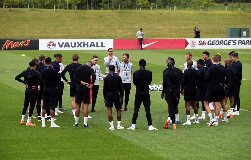 England assistant coach Steve Holland speaks to the players while manager Gareth Southgate listens during a training session at St Georges Park on May 28, 2018 in Burton-upon-Trent, England. Nick Potts / AP Photo