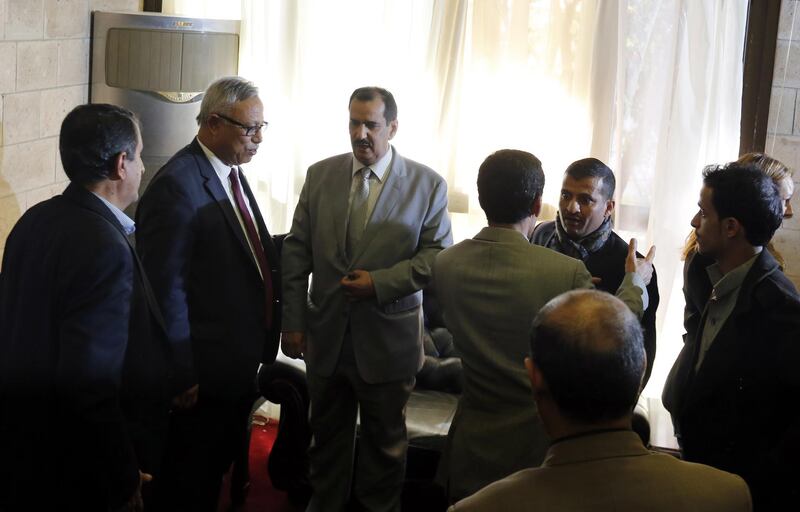 Kuwaiti ambassador to Yemen Fahd Almeie (C) talks to a Houthi delegation before departing on a Kuwait-chartered plane to UN-sponsored peace talks in Sweden. EPA