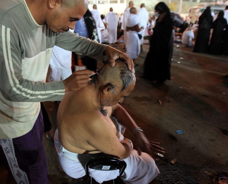 epa02994846 A muslim pilgrim gets his head shaved after casting stones at the symbolic devil represented by a Jamarat (Burning Coal) during the Muslim's Hajj 2011 pilgrimage in the tent city of Mina near Mecca, Saudi Arabia, 06 November 2011.  Millions of Muslims arrived in Saudi Arabia to perform their Hajj. The Hajj 2011 takes place from 04 to 09 November.  EPA/AMEL PAIN *** Local Caption ***  02994846.jpg