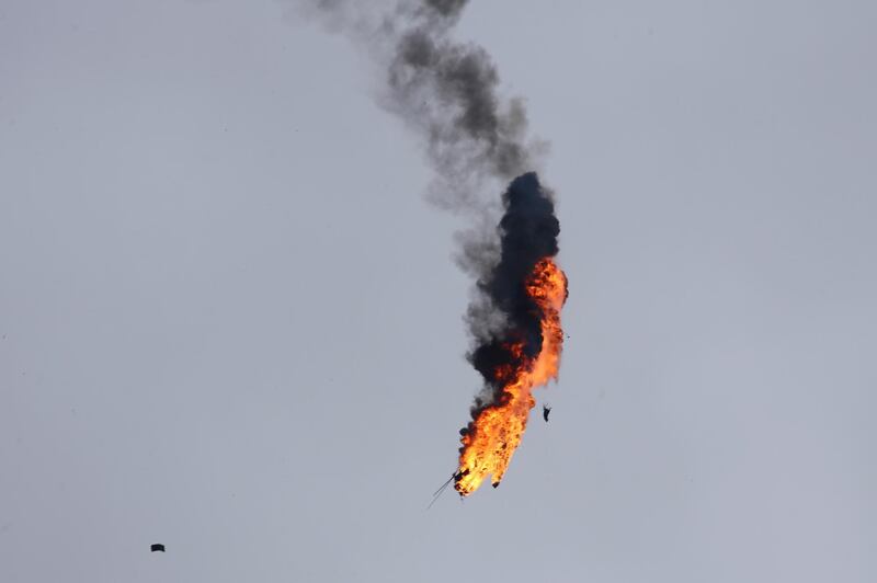 Syrian government helicopter bursts in flames after it was shot by a missile in Idlib province, Syria, Tuesday, Feb. 11, 2020. Syrian rebels shot down a government helicopter Tuesday in the country's northwest where Syrian troops are on the offensive in the last rebel stronghold. (AP Photo/Ghaith Alsayed)