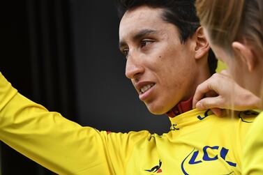 Colombia's Egan Bernal waves as he celebrates his overall leader's yellow jersey on the podium of Stage 19. Jeff Pachoud / AFP