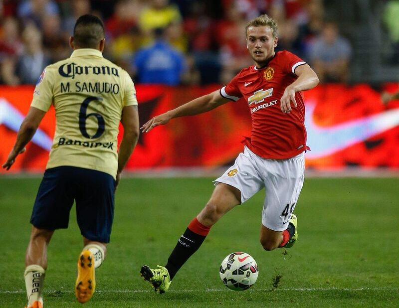 Manchester United's James Wilson dribbles the ball against Miguel Samudio of Club America during their pre-season friendly on Friday night in Seattle. Otto Greule Jr / Bongarts / Getty Images