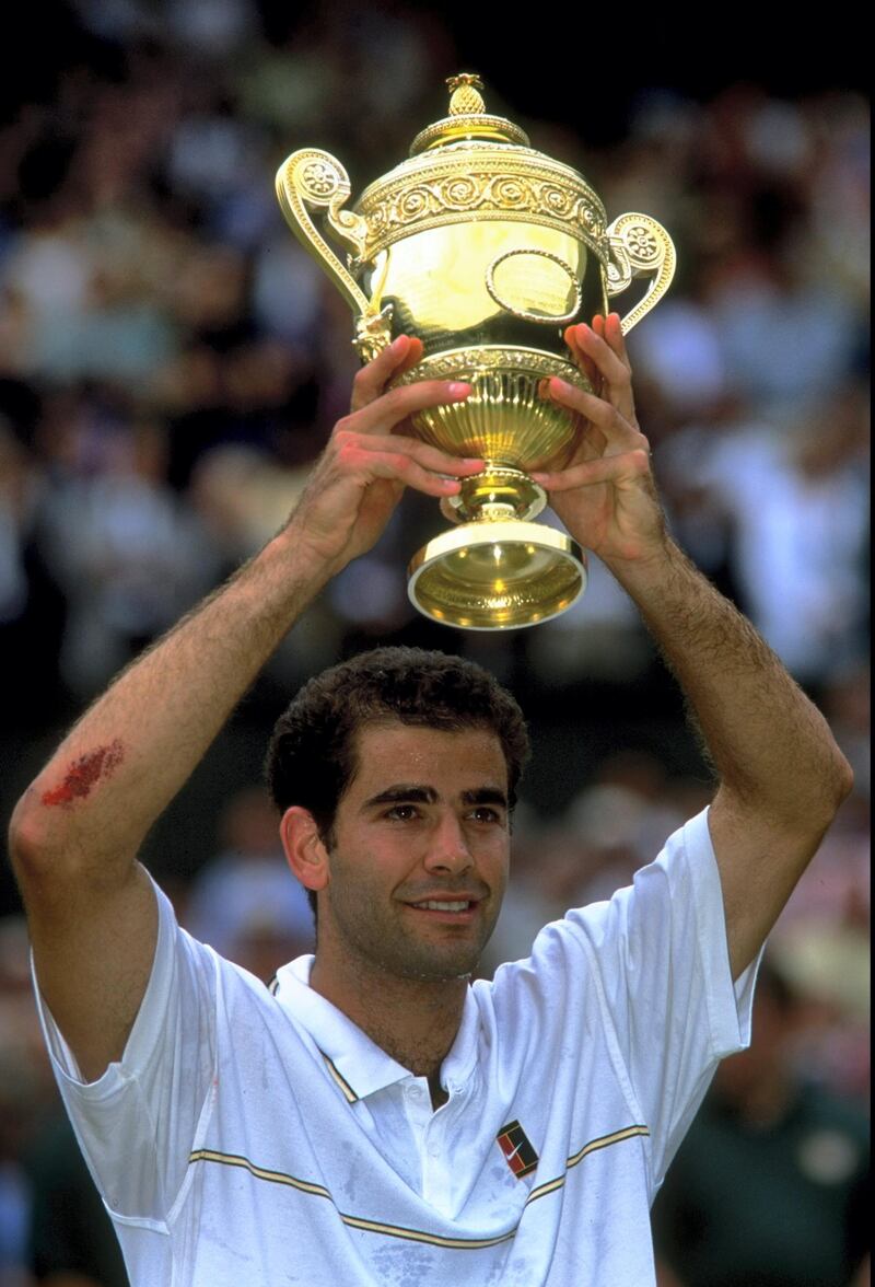 4 Jul 1999:  Pete Sampras of the United States proudly holds aloft the trophy after winning the Men's Singles Championship Final match against Andre Agassi also of the United States played at the All England Club in Wimbledon, England.  The match finished in a comprehensive straight sets victory for Pete Sampras and he went on to equal Roy Emersons record of twelve Grand Slam Singles titles. \ Mandatory Credit: Gary M Prior/Allsport
