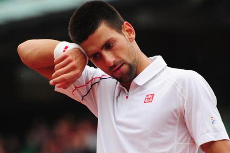 PARIS, FRANCE - JUNE 05:  Novak Djokovic of Serbia  reacts in his men's singles quarter final match against Jo-Wilfried Tsonga of France during day 10 of the French Open at Roland Garros on June 5, 2012 in Paris, France.  (Photo by Mike Hewitt/Getty Images)