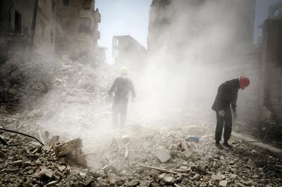 Firemen sift through the rubble for body parts in the dust in Raqqa. David Pratt for The National