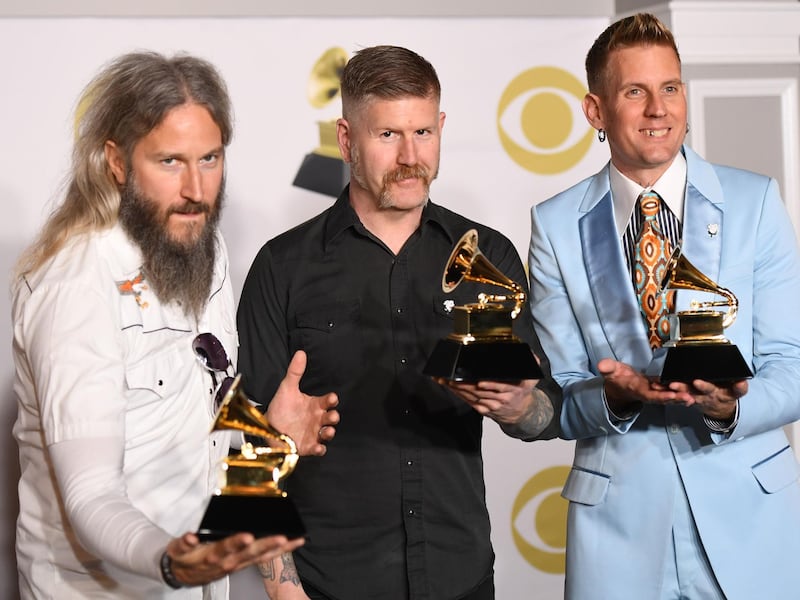 Mastodon poses with the trophy for Best Metal Performance in the press room. AFP
