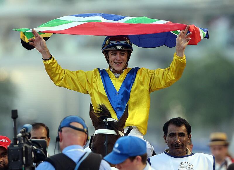 Jockey Christophe Soumillon, riding Mubtaahij, celebrates winning the UAE Derby during the Dubai World Cup at the Meydan Racecourse in Dubai. ( Satish Kumar / The National )