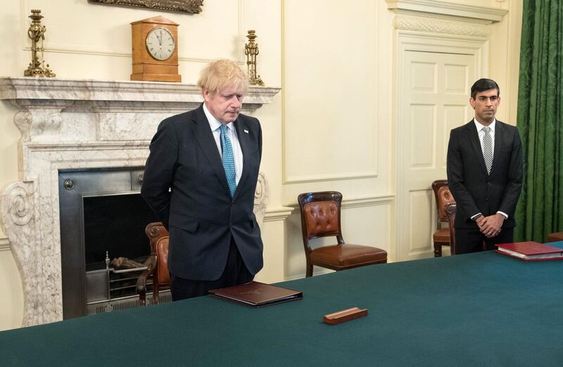 LONDON, ENGLAND  - APRIL 28: Prime minister Boris Johnson and Chancellor of the Exchequer Rishi Sunak (right) stand inside the Cabinet Room of 10 Downing Street, London, to observe a minute's silence in tribute to the NHS staff and key workers who have died during the coronavirus outbreak on April 28, 2020 in London, England. The moment of silence, commemorating the key workers who have died during the Covid-19 pandemic, was timed to coincide with International Workers' Memorial Day. At least 90 NHS workers are reported to have died in the last month, in addition to transport employees and other key workers. (Photo by Stefan Rousseau WPA Pool/Getty Images)
