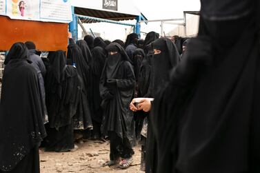 Women line up for aid supplies at Al Hol camp in Hasakeh province, Syria. AP
