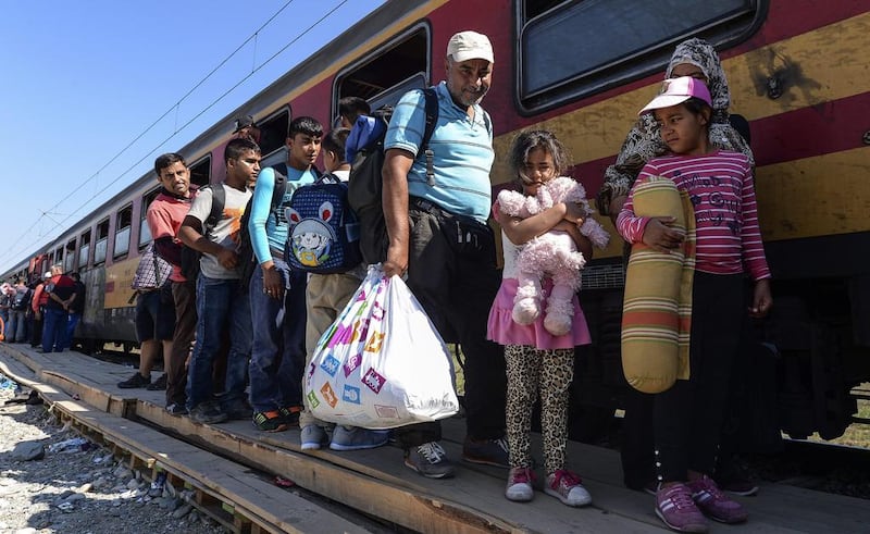 Refugees board a train heading to the border with Serbia, near the Macedonian town of Gevgelija, on September 13, 2015. Georgi Licovski/EPA