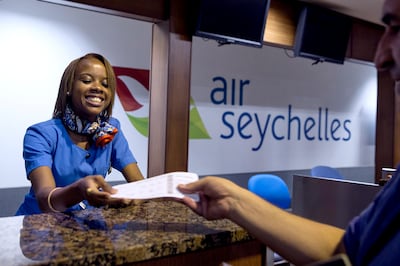 MAHE, SEYCHELLES, Mar. 10, 2015:  
An Air Seychelles staff work at the check-in desk at the airport in Victoria, the Republic of Seychelles' capital, on Mahe island, as seen on on Tuesday, Mar. 10, 2015.  Etihad Airways signed a deal with Seychelles government in January 2012, acquiring 40-percent stake in Air Seychelles. Seychelles, with a population of just over 90,000 - the smallest of any African states - is a member of the African Union. (Silvia Razgova / The National)  (Usage: undated, Section: BIZ, Reporter: Shereen Elgazzar) *** Local Caption ***  150310-Seychelles0577.jpg