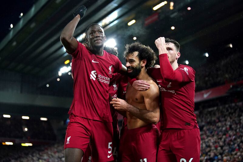 Liverpool's Mohamed Salah, centre, celebrates with teammates after scoring his side's sixth goal against Manchester United at Anfield in Liverpool, England, Sunday, March 5, 2023. PA