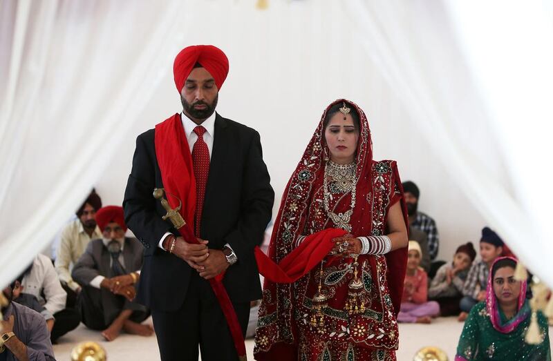 Devinder Singh and Manpreet Kaur from Punjab, India, during their marriage ceremony at the temple. The temple attracts Sikh couples from around the world who want a destination wedding.