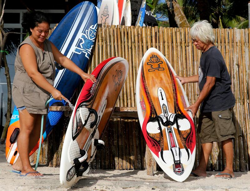 Filipinos clean surfboards outside their closed shop as the government implements the temporary closure of the country's most famous beach resort island of Boracay on Thursday, April 26, 2018. Aaron Favila / AP Photo
