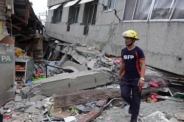 A fireman inspects a damaged market in the quake-hit town of Padada, Davao del Sur province, Philippines. EPA