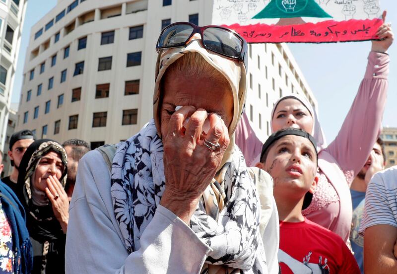 A Lebanese protester wipes her tears during a demonstration in central Beirut's Martyr Square. AFP