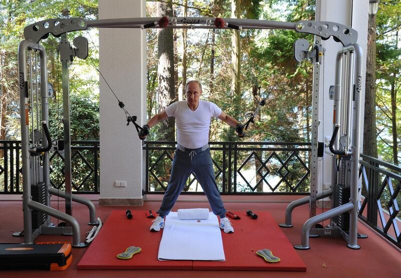 Russian President Vladimir Putin exercises during his meeting with Prime Minister Dmitry Medvedev, at the Black Sea resort of Sochi, Russia. RIA Novosti / AP Photo