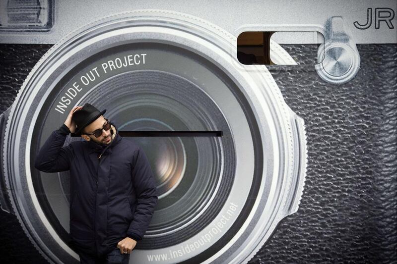 French artist and photographer JR poses during the installation of portraits from his “Inside Out” project in Paris. To mark the release of Alastair Siddons’ documentary “Inside Out” which follows JR around the globe, the artist will be transforming one of the towers of the French National Library (BNF) into a giant photo booth by using an optical illusion technique. Joel Saget / Topshots / AFP Photo