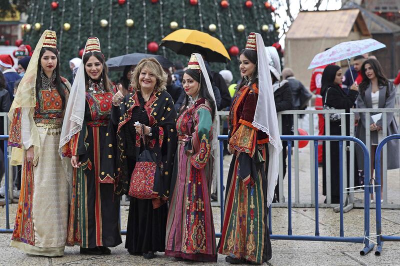 People gather outside the Church of the Nativity.  AFP