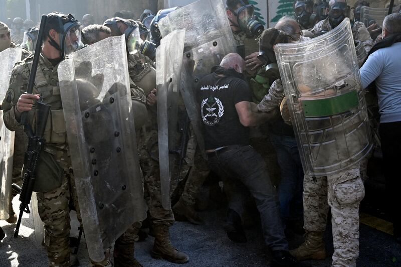 Retired members of the Lebanese security forces clash with soldiers during the protest. EPA