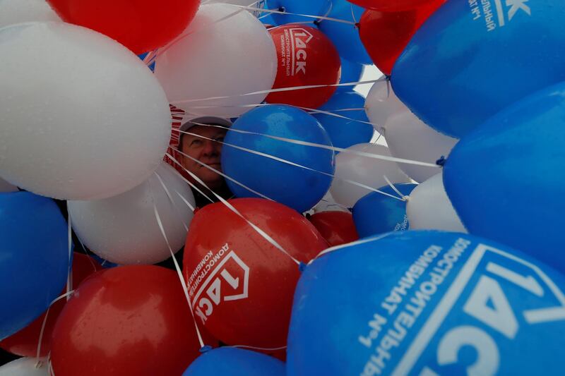 A man holds balloons before a May Day rally in Moscow. Maxim Shemetov / Reuters