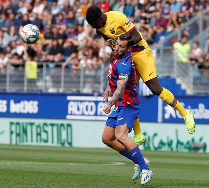 FC Barcelona's French defender Samuel Umtiti (up) vies for the ball with SD Eibar's striker Sergi Enrich (down) during the Spanish LaLiga  soccer match between SD Eibar and FC Barcelona played at Ipurua stadium, in Eibar, northern Spain.  EPA