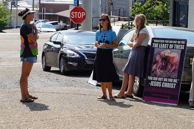 A clinic escort speaks with anti-abortion protesters. Willy Lowry / The National 