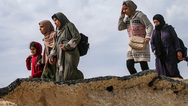 Palestinians, including women and children, cross from northern to southern Gaza along Al Rashid road. EPA