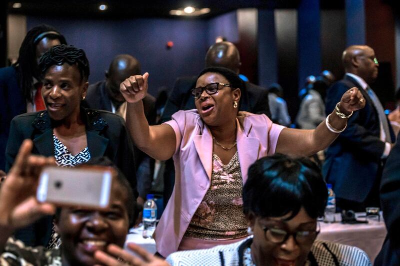 Zimbabwe's members of parliament celebrate after Mugabe's resignation on November 21, 2017 in Harare. Jekesai Njikizana / AFP