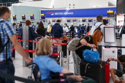 Passengers check in for their British Airways flight at London Heathrow. Photographer: Hollie Adams / Bloomberg