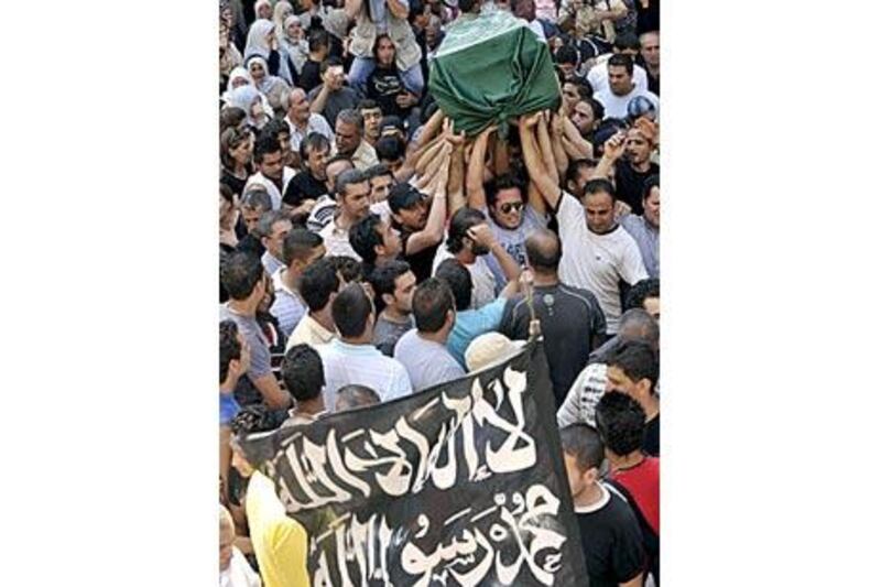 Zeina Miri's relatives and friends carry her coffin covered with the Islamic flag during her funeral.