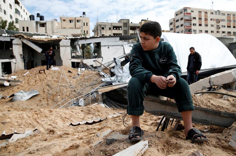 A Palestinian boy sits next to the destroyed Hamas site following Israeli air strikes in Gaza City. Reuters