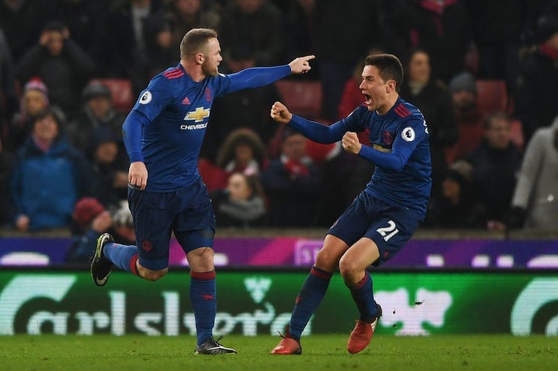 Wayne Rooney, left, celebrates his equalising goal against Stoke City. His injury-time free-kick ensured he became Manchester United's all-time leading goal-scorer. Getty