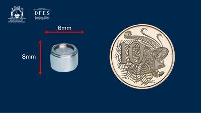 The small silver capsule compared in size with an Australian 10 cent coin. AAP