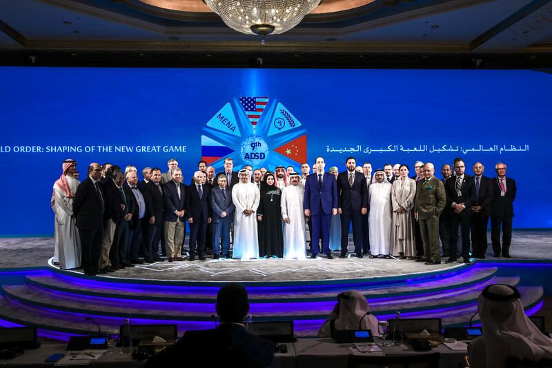 Delegates and speakers with Dr Anwar Gargash, centre, Diplomatic Adviser to the UAE President, at the Abu Dhabi Strategic Debate. All photos: Victor Besa / The National