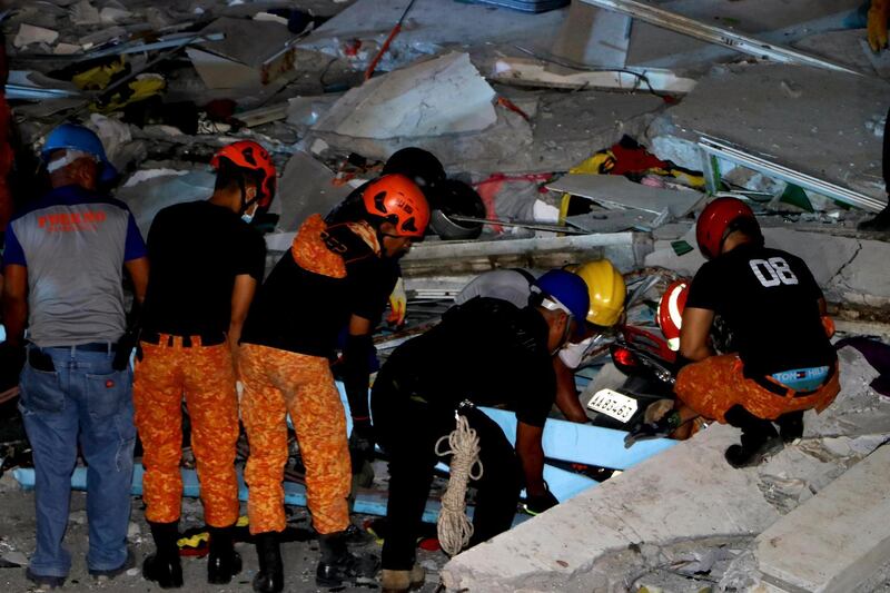 Emergency responders continue search operations at a damaged commercial building following an earthquake in Porac town, Pampanga Province, north of Manila. EPA