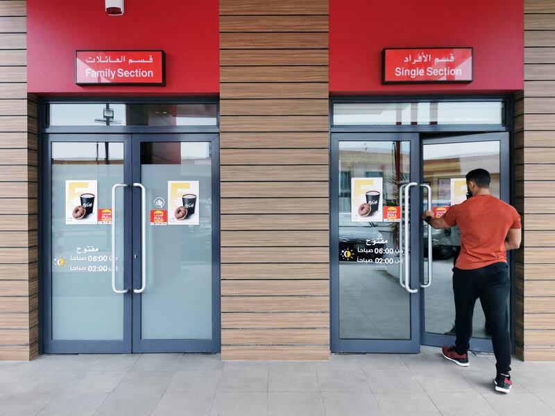 A Saudi man walks through the "Single Section" entrance at a McDonald's outlet in Khobar. Saudi authorities announced on December 8, 2019 that restaurants would no longer be required to segregate unrelated male and female customers. Reuters