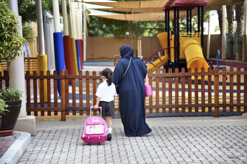 An Emirati woman walks with her daughter at the Al-Mizhar American Academy as the government re-opens schools after months in the wake of Covid-19 pandemic in Dubai, UAE, Sunday, Aug. 30, 2020. (Photos by Shruti Jain - The National)